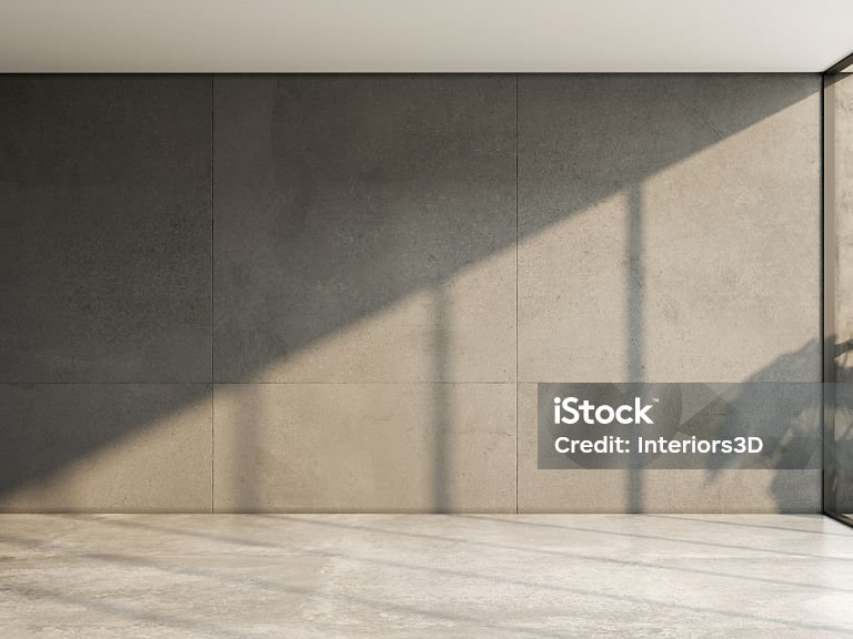Wohnraum mit großformatigen Wandplatten und durchgehendem Steinboden